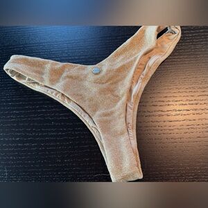 Sparkling golden bikini bottom.